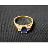 A diamond and two colour purple/blue stone trilogy ring,
