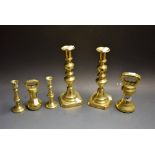 A pair of early 19th century brass candlesticks, baluster style; another pair,