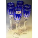 Waterford Crystal - a set of four Waterford crystal blue Clarendon pattern champagne flutes