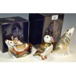 A Royal Crown Derby paperweight, Wolf, boxed, gold stopper; Reindeer, boxed, gold stopper; Puffin,