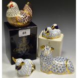 A Royal Crown Derby paperweight, Hen, boxed, gold stopper; Twin Lambs, boxed, gold stopper; Sheep,