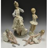 A Nao figure of a Ballerina tying her shoes;