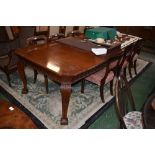 An early 20th century mahogany wind out dining table (three leaves)