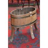 A 19th century oval coopered wine cooler, outswept legs, 61cm high,