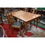 An Arts and Crafts oak wood wind out dining table (two leaves);