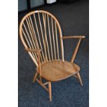 An Ercol spindle backed open armchair.