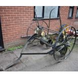 An early 20th century trailer pulled seed drill