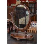 A large Victorian mahogany oval dressing table mirror