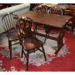 An oak refectory style dining table, lyre shaped end supports; four hoop backed,