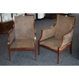 A pair of Edwardian mahogany bergere library chairs, curved rectangular backs,