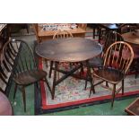 An Ercol drop leaf kitchen table;