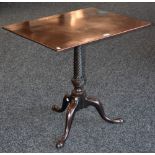 A George III mahogany tilt top tripod table, rounded rectangular top,