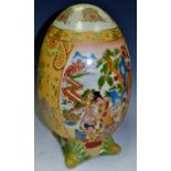 An Oriental Satsuma temple egg, hand painted with rural scenes,