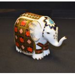 A Royal Crown Derby paperweight, Baby Imari Elephant, raised trunk, gold stopper,