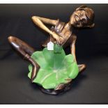 A bronzed metal figure of a pixie