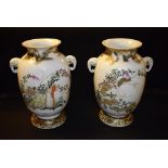 A pair of Oriental vases, twin handles modelled as elephants, hand painted with flowers, birds,
