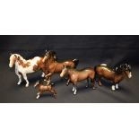 A Beswick ceramic model of a Skewbald horse; others, prancing horse, foal,