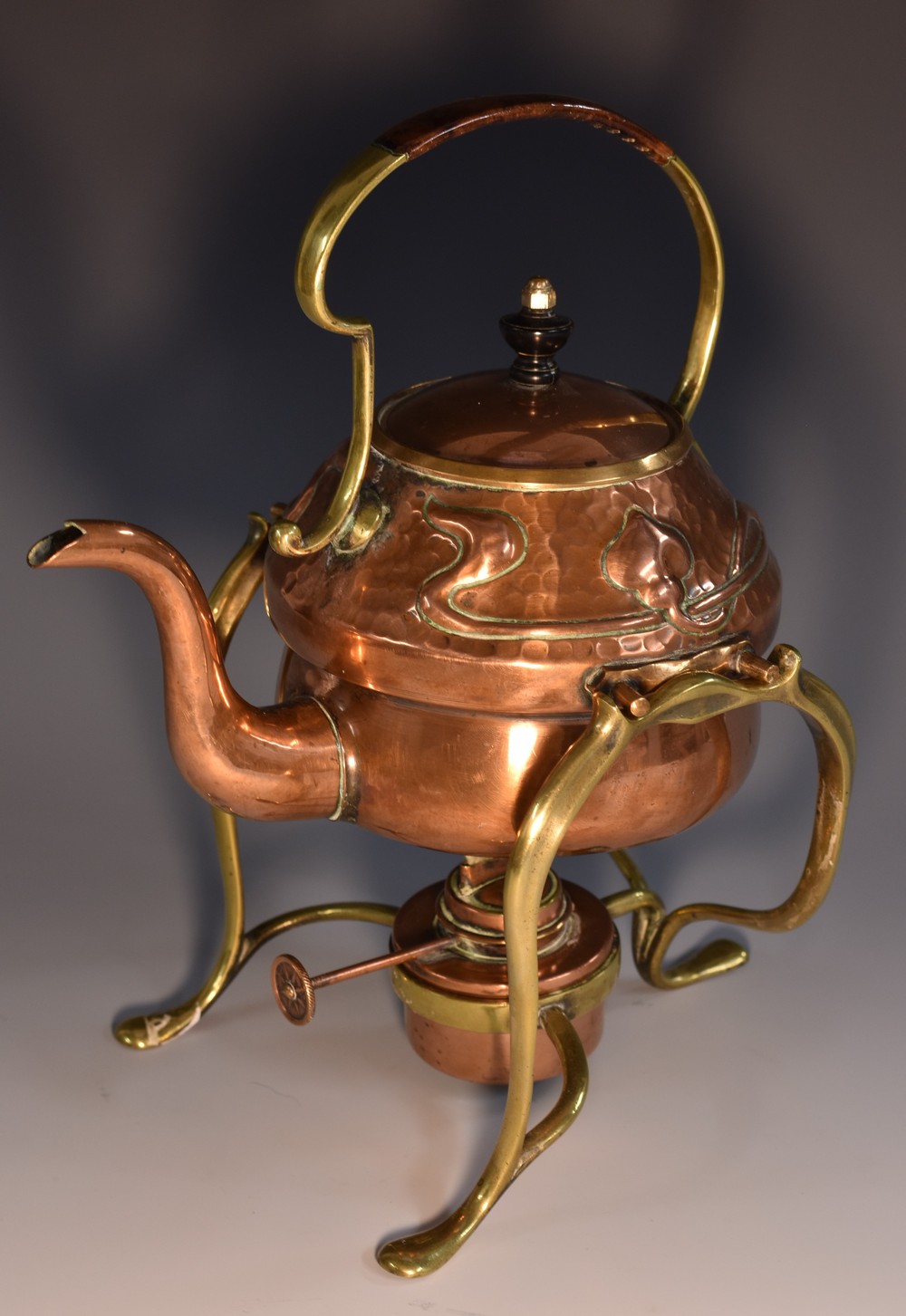An Art Nouveau copper and brass tea kettle on stand,