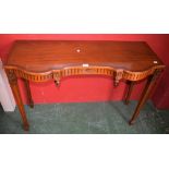 A reproduction Regency revival side table, serpentine top, inlaid stringing,