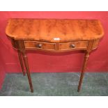 A reproduction walnut veneered serpentine side table, two fitted drawers,
