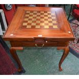 A modern hardwood games compendium table with brass inlaid playing board and brass stringing,