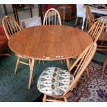 An Ercol dropleaf table and four Ercol spindle back chairs