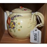 An 18th century globular teapot and cover, decorated with stylised flowers and foliage in colours,