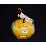 A novelty majolica type water melon biscuit barrel surmounted with a child,