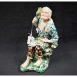 A Japanese figure, of an emaciated elder, he seats on a mossy rock with a toad on his shoulder,