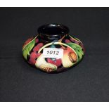 A contemporary Moorcroft vase tube lined with figs,