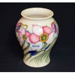 A contemporary Moorcroft vase tube lined with pink flowers,