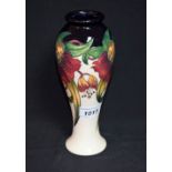 A contemporary Moorcroft vase tube lined with lilies,