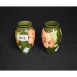 Moorcroft - a pair of coral hibiscus small baluster vases