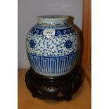 A Chinese ginger jar, painted in underglaze blue with flowers and foliate tendrils,