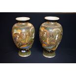 A pair of Japanese Satsuma vases, decorated with immortals,