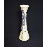 A contemporary Moorcroft vase tube lined with bluebells,