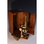 A 19th century lacquered brass monocular microscope, rack-and-pinion focusing, adjustable stage,
