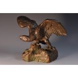 French School (early 20th century), a dark patinated bronze, of an eagle on a rocky outcrop, 15.