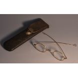 A pair of 19th century gold spectacles, oval lenses, arched bridge, curved temple struts,