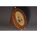 A Cantonese sandalwood oval easel photograph frame,