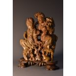 A Chinese soapstone carving, of Guanyin and companion, hardwood base,