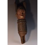Tribal Art - an African figural house post totem, carved with a mask with scarified features,