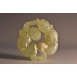 A Chinese pale green jade roundel, carved as an erotic subject,