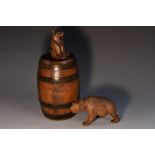 A Black Forest spirit barrel, surmounted by a stopper carved as a seated bear,