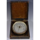 A 19th century brass travelling aneroid barometer, 11cm silvered register inscribed Compensated,