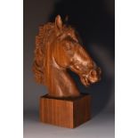 A hardwood desk sculpture, carved as the head of a horse, rectangular base, 28cm high,