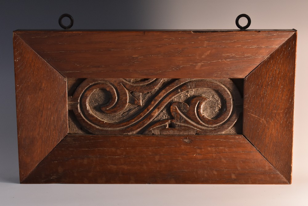 A 16th century oak panel section, carved in relief with scrolling acanthus, 6cm x 18cm, c.