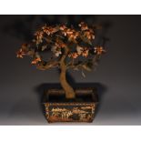 A Chinese black lacquer bombé shaped table jardiniere,