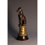A 19th century dark patinated desk bronze, of a hound, seated, polished socle,