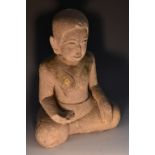 Antiquities - an Asian stone Buddha, seated in meditation,